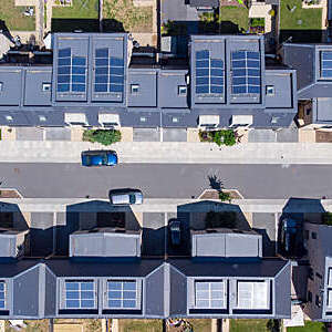 Overhead aerial view of a newly built housing development with solar panels installed in all the homes helping to aid sustainable living.