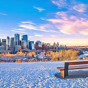 A colorful and cloudy morning sunrise sky over the downtown Calgary skyline in the winter.